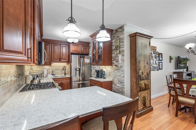 17-85 215th St Unit 4B, Bayside, NY 11360 - kitchen with stainless steel appliances, tasteful backsplash, crown molding, a sink, and light wood-type flooring