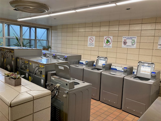 17-85 215th St Unit 4B, Bayside, NY 11360 - shared laundry room with washer / dryer, light tile patterned floors, and tile walls