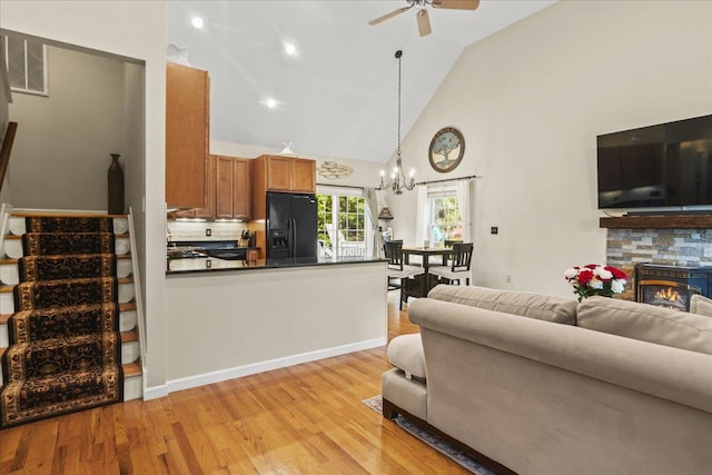 3 Pine Ln, Greenwood Lake, NY 10925 - living area featuring ceiling fan, high vaulted ceiling, a chandelier, light wood-style flooring, and a stone fireplace