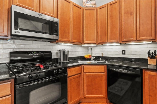 3 Pine Ln, Greenwood Lake, NY 10925 - kitchen featuring black appliances, a sink, backsplash, dark stone counters, and brown cabinets