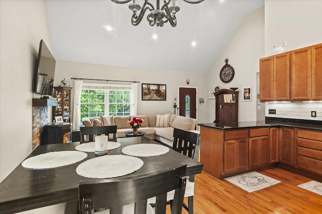3 Pine Ln, Greenwood Lake, NY 10925 - dining space with high vaulted ceiling, light wood-style flooring, and a chandelier