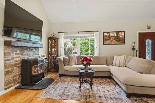 3 Pine Ln, Greenwood Lake, NY 10925 - living area with a wood stove, wood finished floors, vaulted ceiling, and baseboards