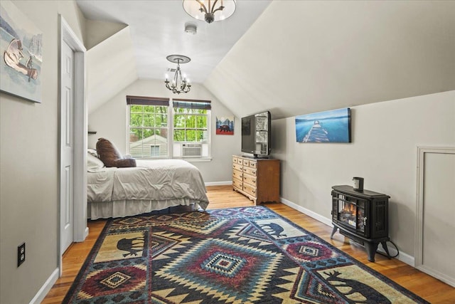 3 Pine Ln, Greenwood Lake, NY 10925 - bedroom featuring light wood finished floors, lofted ceiling, a wood stove, and baseboards