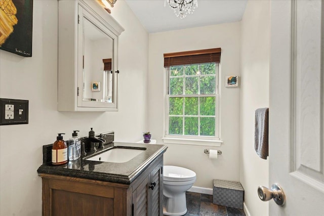 3 Pine Ln, Greenwood Lake, NY 10925 - half bathroom with toilet, vanity, baseboards, and stone finish flooring