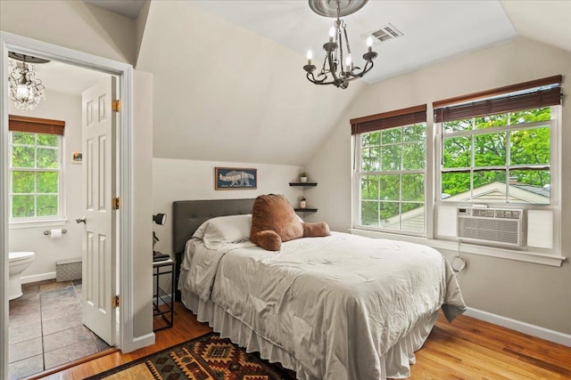 3 Pine Ln, Greenwood Lake, NY 10925 - bedroom featuring a chandelier, lofted ceiling, wood finished floors, baseboards, and ensuite bath