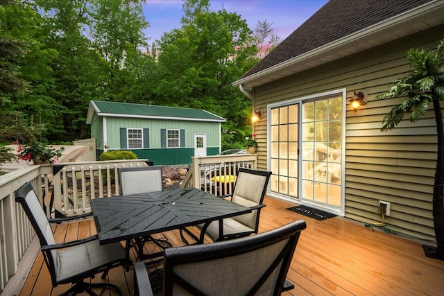 3 Pine Ln, Greenwood Lake, NY 10925 - deck at dusk with outdoor dining space and an outbuilding