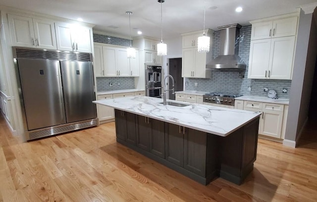 4 Coventry Ct, Wheatley Heights, NY 11798 - kitchen featuring appliances with stainless steel finishes, wall chimney exhaust hood, a sink, white cabinetry, and recessed lighting