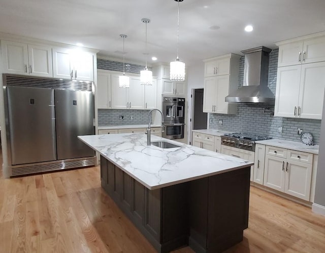 4 Coventry Ct, Wheatley Heights, NY 11798 - kitchen featuring stainless steel appliances, wall chimney exhaust hood, a sink, decorative backsplash, and light wood-style floors