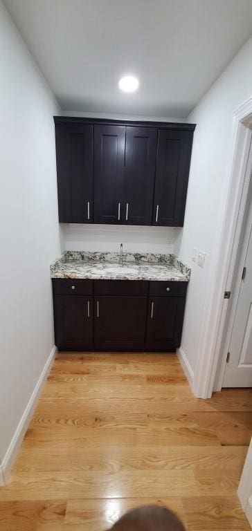 4 Coventry Ct, Wheatley Heights, NY 11798 - bar with baseboards, a sink, and light wood-type flooring