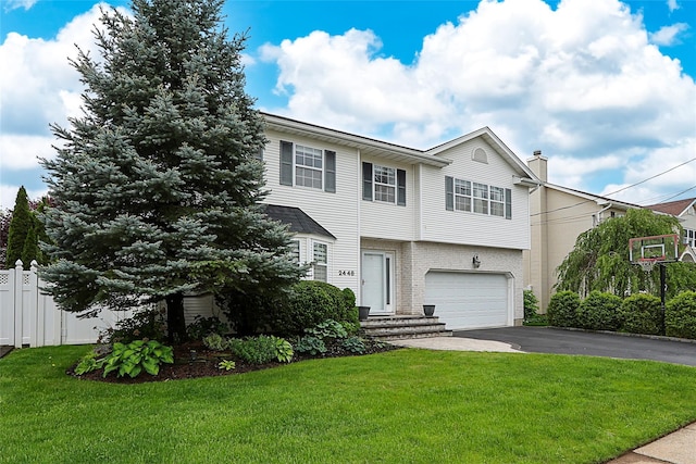 2448 6th Ave, East Meadow, NY 11554 - view of front of house featuring driveway, a garage, and a chimney