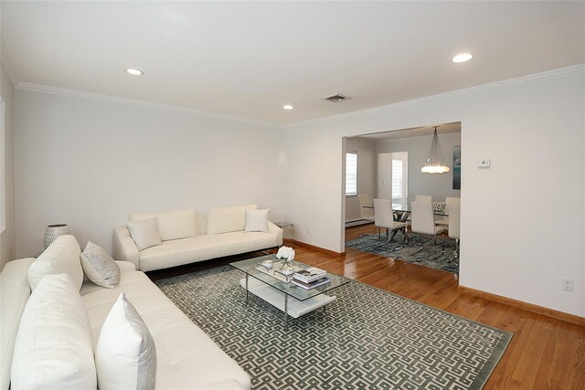 2448 6th Ave, East Meadow, NY 11554 - living room with baseboards, a chandelier, crown molding, wood finished floors, and recessed lighting