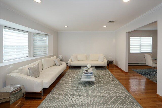 2448 6th Ave, East Meadow, NY 11554 - living area with a baseboard heating unit, crown molding, recessed lighting, wood finished floors, and baseboards