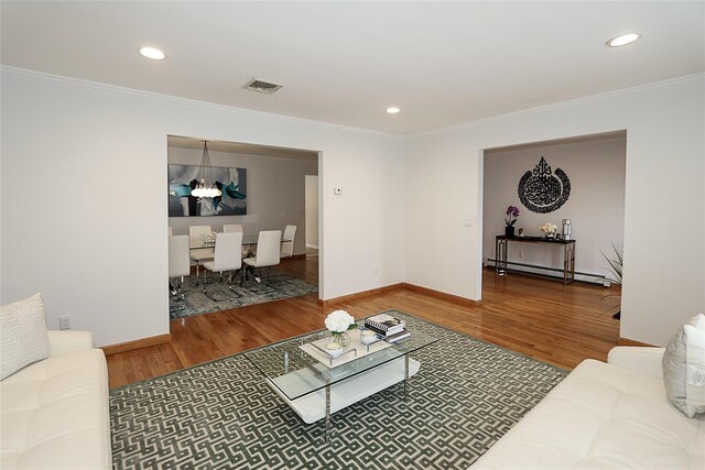 2448 6th Ave, East Meadow, NY 11554 - living area with ornamental molding, wood finished floors, recessed lighting, a baseboard heating unit, and baseboards