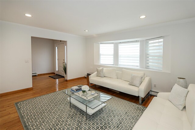 2448 6th Ave, East Meadow, NY 11554 - living area featuring crown molding, a baseboard heating unit, wood finished floors, a baseboard radiator, and baseboards