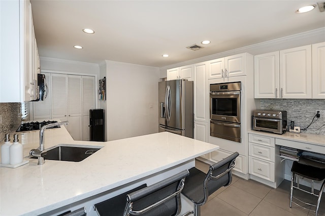 2448 6th Ave, East Meadow, NY 11554 - kitchen with appliances with stainless steel finishes, a warming drawer, a sink, crown molding, and backsplash
