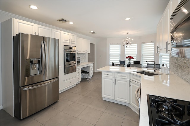 2448 6th Ave, East Meadow, NY 11554 - kitchen with stainless steel appliances, a sink, a chandelier, white cabinets, and recessed lighting
