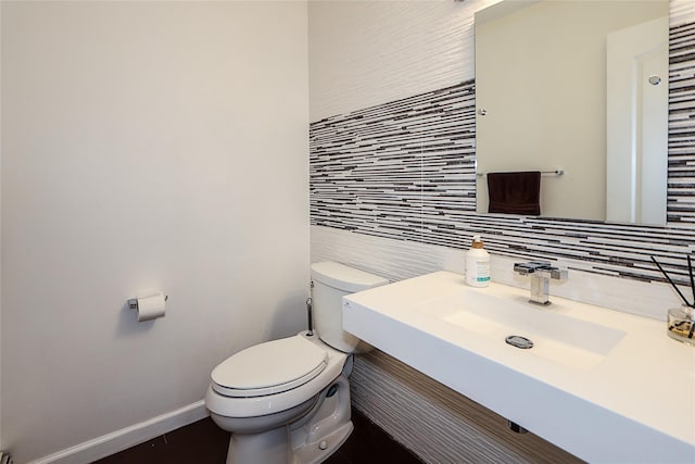 2448 6th Ave, East Meadow, NY 11554 - half bath featuring backsplash, toilet, tile walls, and baseboards