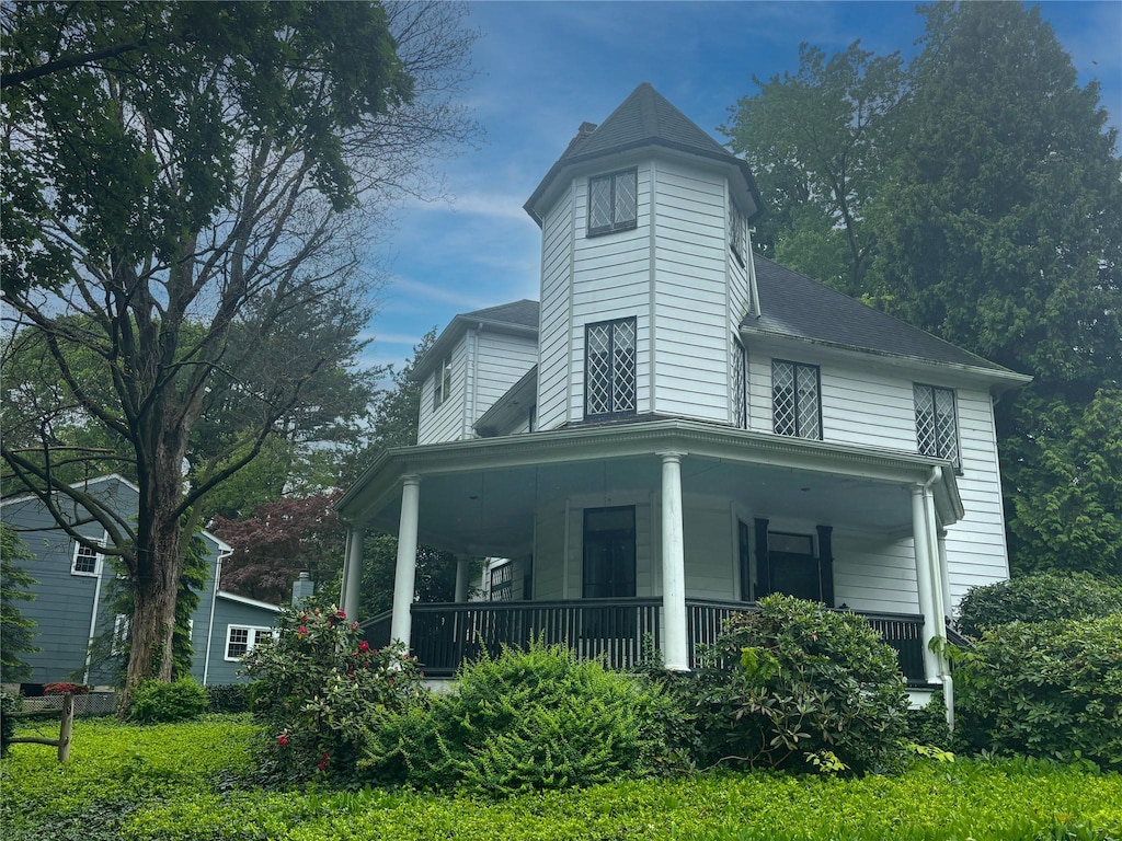 rear view of house with covered porch