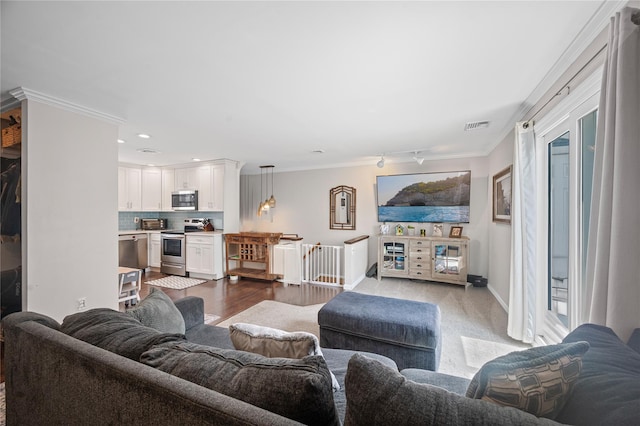 116 Westend Ave Unit 12, Freeport, NY 11520 - living area featuring ornamental molding, baseboards, recessed lighting, and plenty of natural light