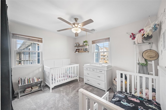 116 Westend Ave Unit 12, Freeport, NY 11520 - bedroom with carpet, ceiling fan, and a crib
