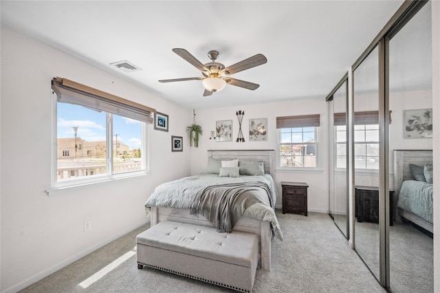 116 Westend Ave Unit 12, Freeport, NY 11520 - bedroom featuring multiple windows, carpet flooring, and baseboards