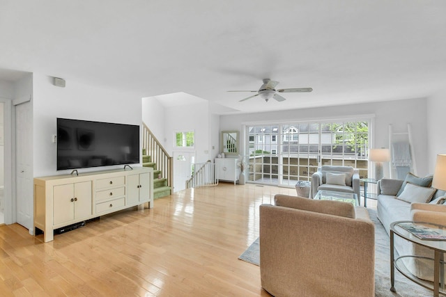 500 Meadow Ct Unit 28, Southold, NY 11971 - living area featuring light wood-style floors, healthy amount of natural light, stairs, and a ceiling fan
