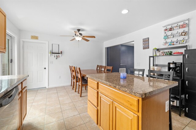 594 County Route 22, Middletown, NY 10940 - kitchen with stainless steel dishwasher, a ceiling fan, a center island, light tile patterned floors, and a breakfast bar
