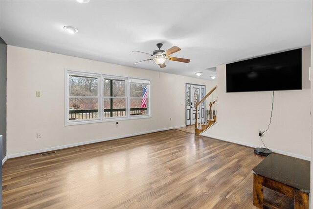 594 County Route 22, Middletown, NY 10940 - unfurnished living room with a ceiling fan, wood finished floors, stairway, and baseboards