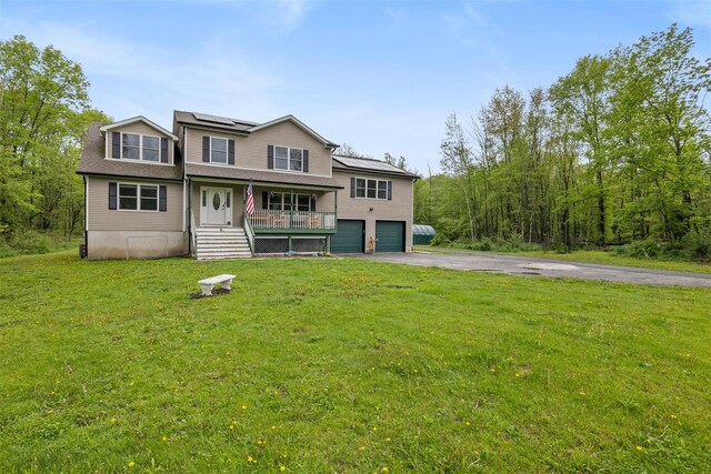 594 County Route 22, Middletown, NY 10940 - view of front facade with asphalt driveway, a porch, solar panels, an attached garage, and a front yard