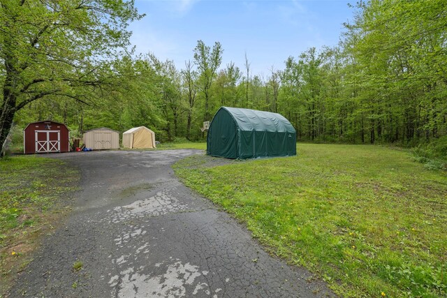 594 County Route 22, Middletown, NY 10940 - view of green lawn featuring a storage shed, an outdoor structure, and a view of trees