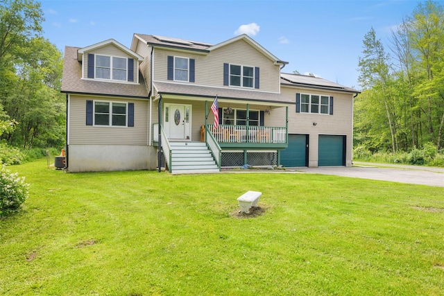 594 County Route 22, Middletown, NY 10940 - view of front of home with covered porch, driveway, a garage, solar panels, and a front lawn