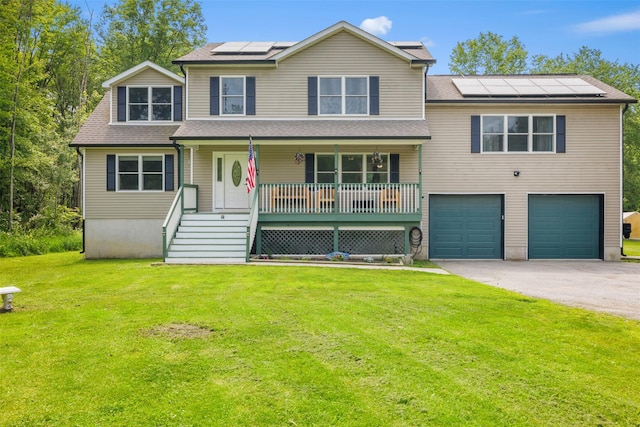 594 County Route 22, Middletown, NY 10940 - view of front of house with a porch, an attached garage, roof mounted solar panels, a front lawn, and driveway