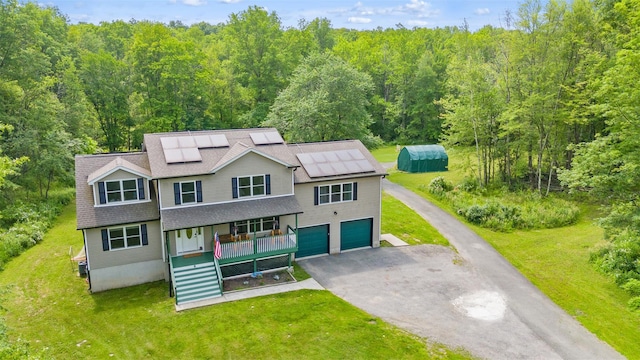 594 County Route 22, Middletown, NY 10940 - view of front of house with a porch, a view of trees, asphalt driveway, and a garage