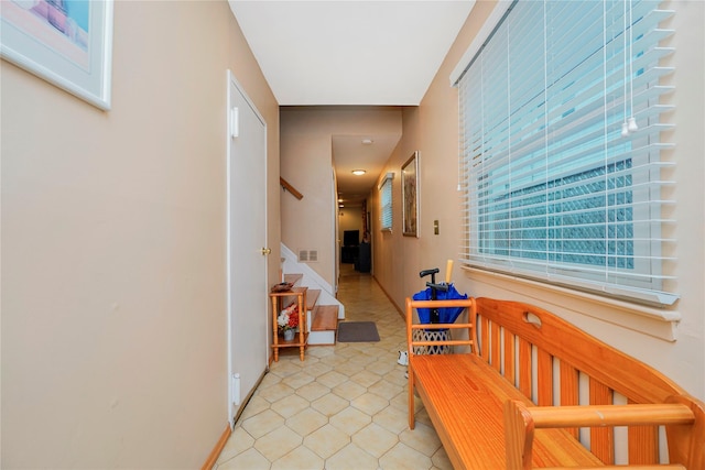 433 Arlene St, Staten Island, NY 10314 - hallway with stairway, light tile patterned flooring, and baseboards