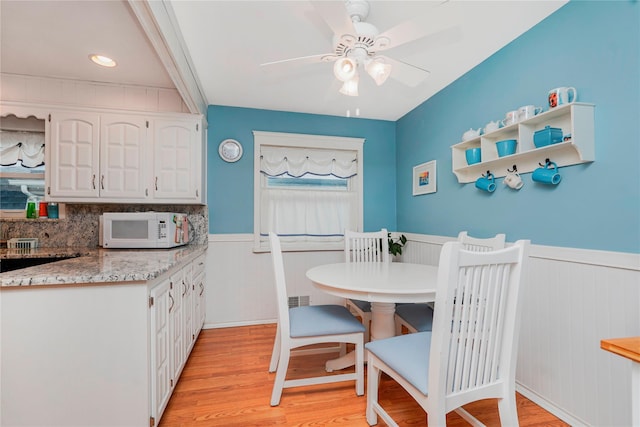 433 Arlene St, Staten Island, NY 10314 - dining area with a wainscoted wall, light wood-style flooring, and a ceiling fan