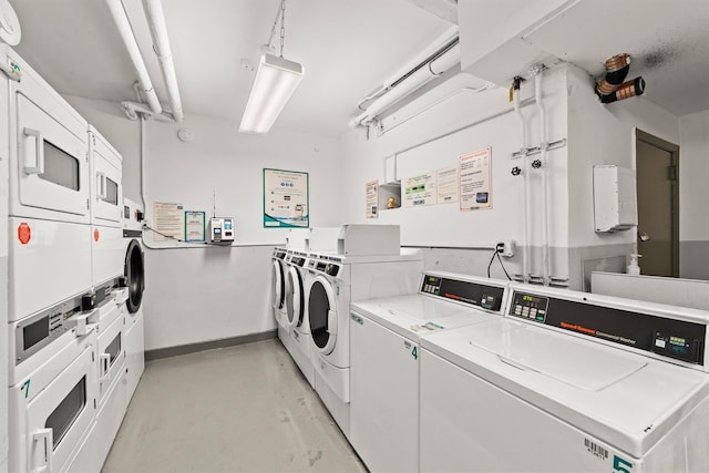 communal laundry room featuring stacked washer / drying machine, washer and clothes dryer, and baseboards