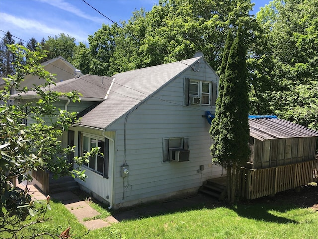 29 Nelshore Dr, Monticello, NY 12701 - view of side of home featuring a shingled roof, cooling unit, and a yard