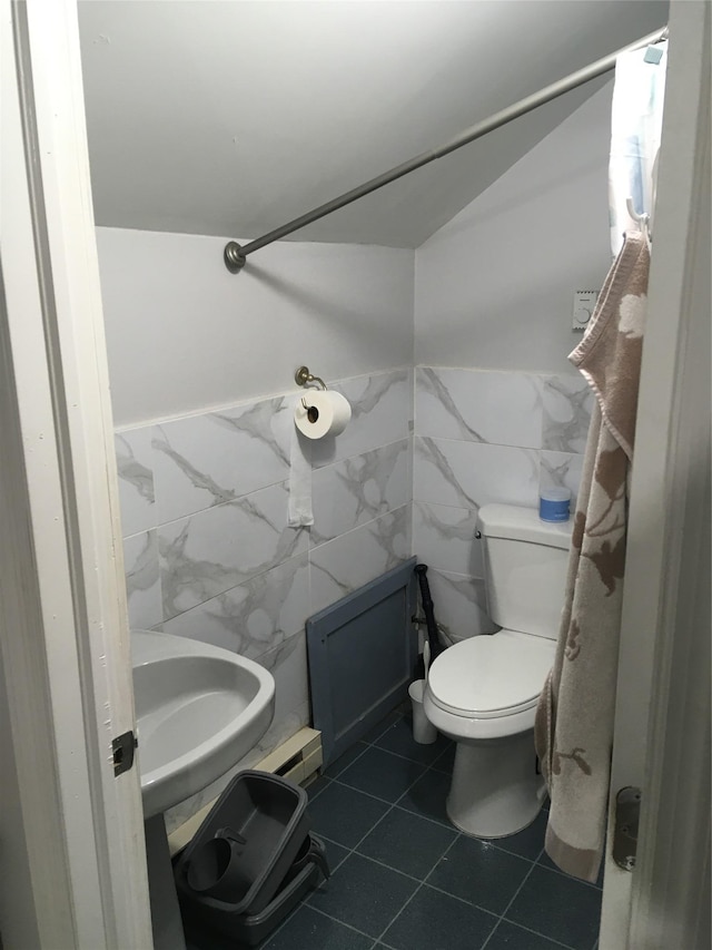 29 Nelshore Dr, Monticello, NY 12701 - bathroom featuring tile walls, a sink, toilet, and tile patterned floors