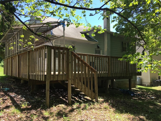 29 Nelshore Dr, Monticello, NY 12701 - rear view of property with a wooden deck, a chimney, a shingled roof, and cooling unit