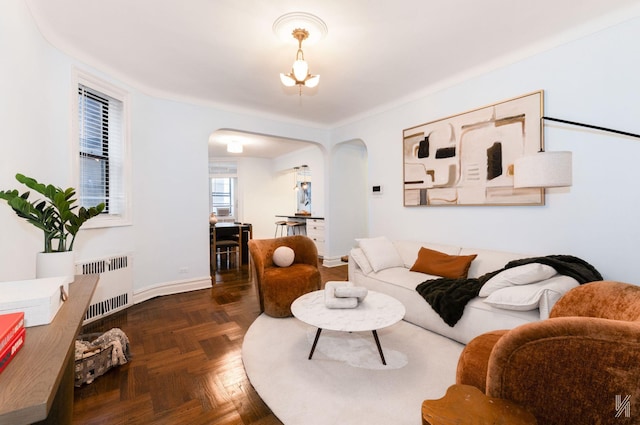 35-06 88th St Unit 5E, Jackson Heights, NY 11372 - living area featuring radiator, arched walkways, baseboards, and a chandelier