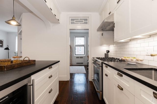 35-06 88th St Unit 5E, Jackson Heights, NY 11372 - kitchen featuring stainless steel gas range oven, under cabinet range hood, dark countertops, beverage cooler, and dark wood finished floors