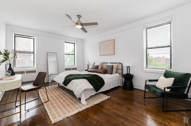 35-06 88th St Unit 5E, Jackson Heights, NY 11372 - bedroom featuring radiator heating unit and dark wood finished floors