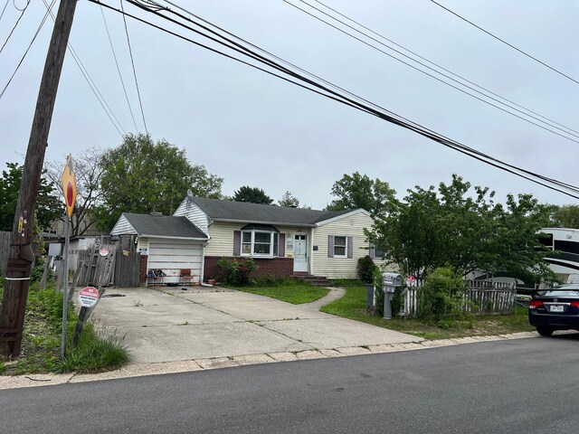 21 Pinetop Dr, Central Islip, NY 11722 - view of front of property with fence, brick siding, and concrete driveway