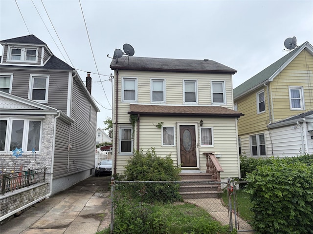 view of front of home with a fenced front yard and entry steps