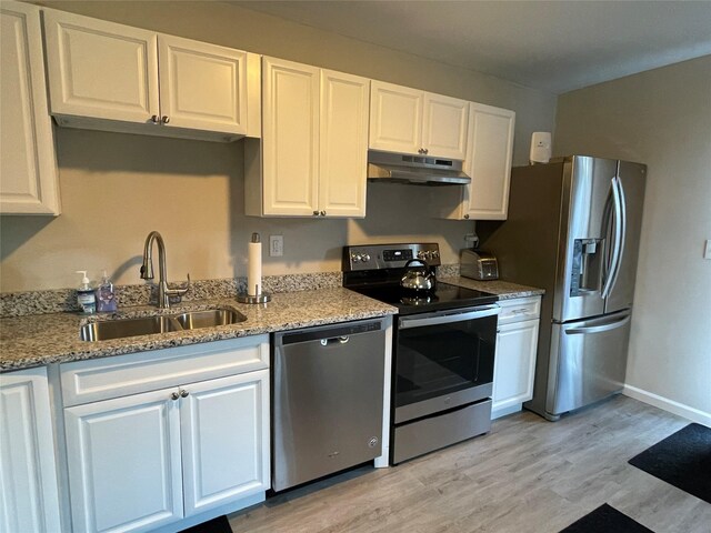 3412 Rte 52, Stormville, NY 12582 - kitchen with stainless steel appliances, under cabinet range hood, a sink, and white cabinetry