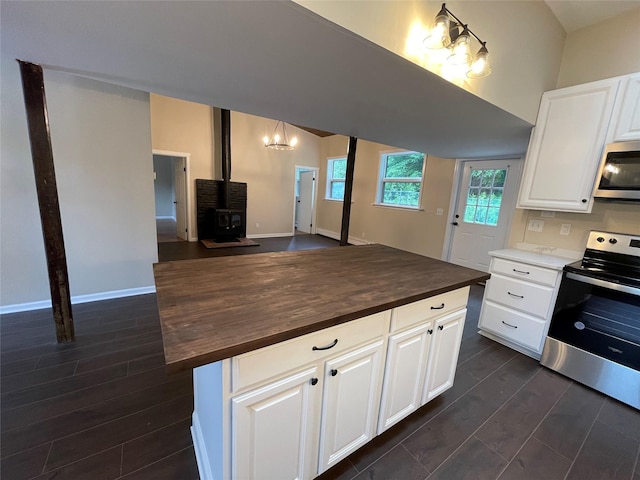 3412 Rte 52, Stormville, NY 12582 - kitchen featuring stainless steel appliances, wood counters, a wood stove, open floor plan, and white cabinetry