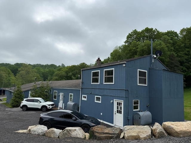 3412 Rte 52, Stormville, NY 12582 - view of front facade with heating fuel, a chimney, and a forest view