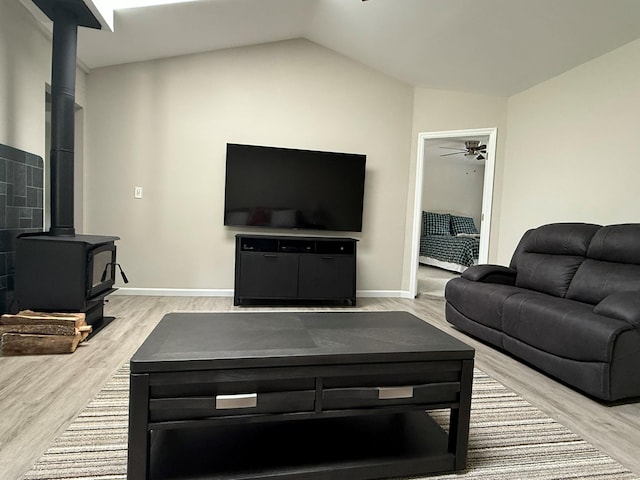 3412 Rte 52, Stormville, NY 12582 - living area with a wood stove, a ceiling fan, light wood-type flooring, lofted ceiling, and baseboards