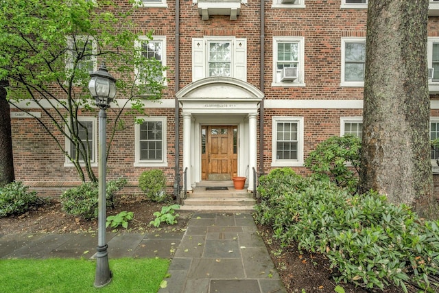 doorway to property featuring brick siding
