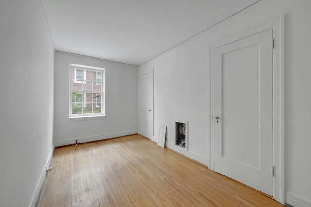 unfurnished living room featuring light wood-style flooring and baseboards